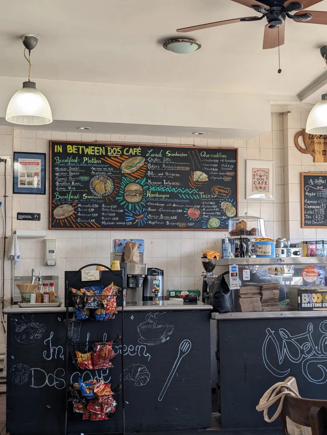Inside In Between Dos Cafe — hand-lettered chalkboard menu over the counter